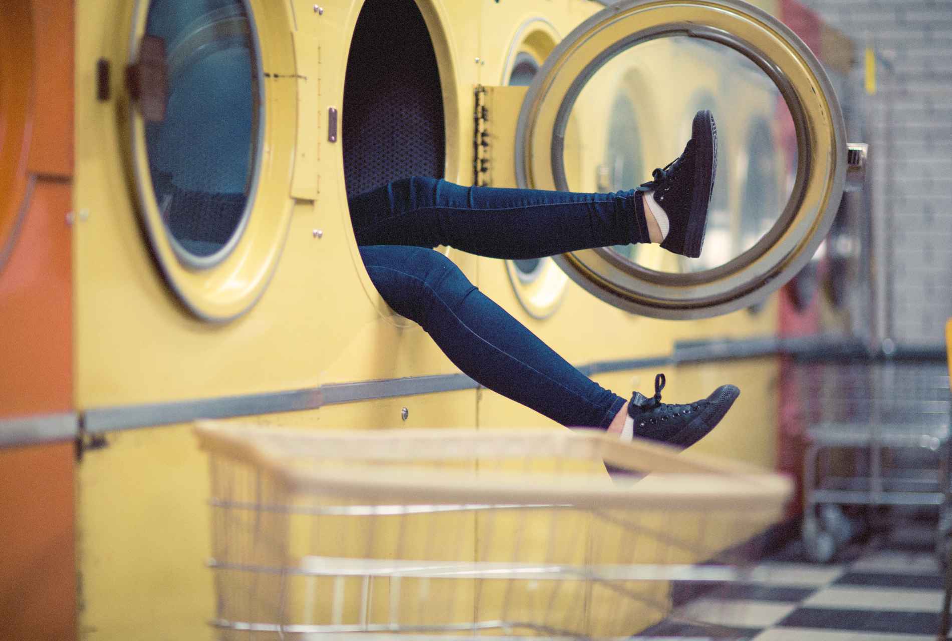 legs hanging out of a dryer
